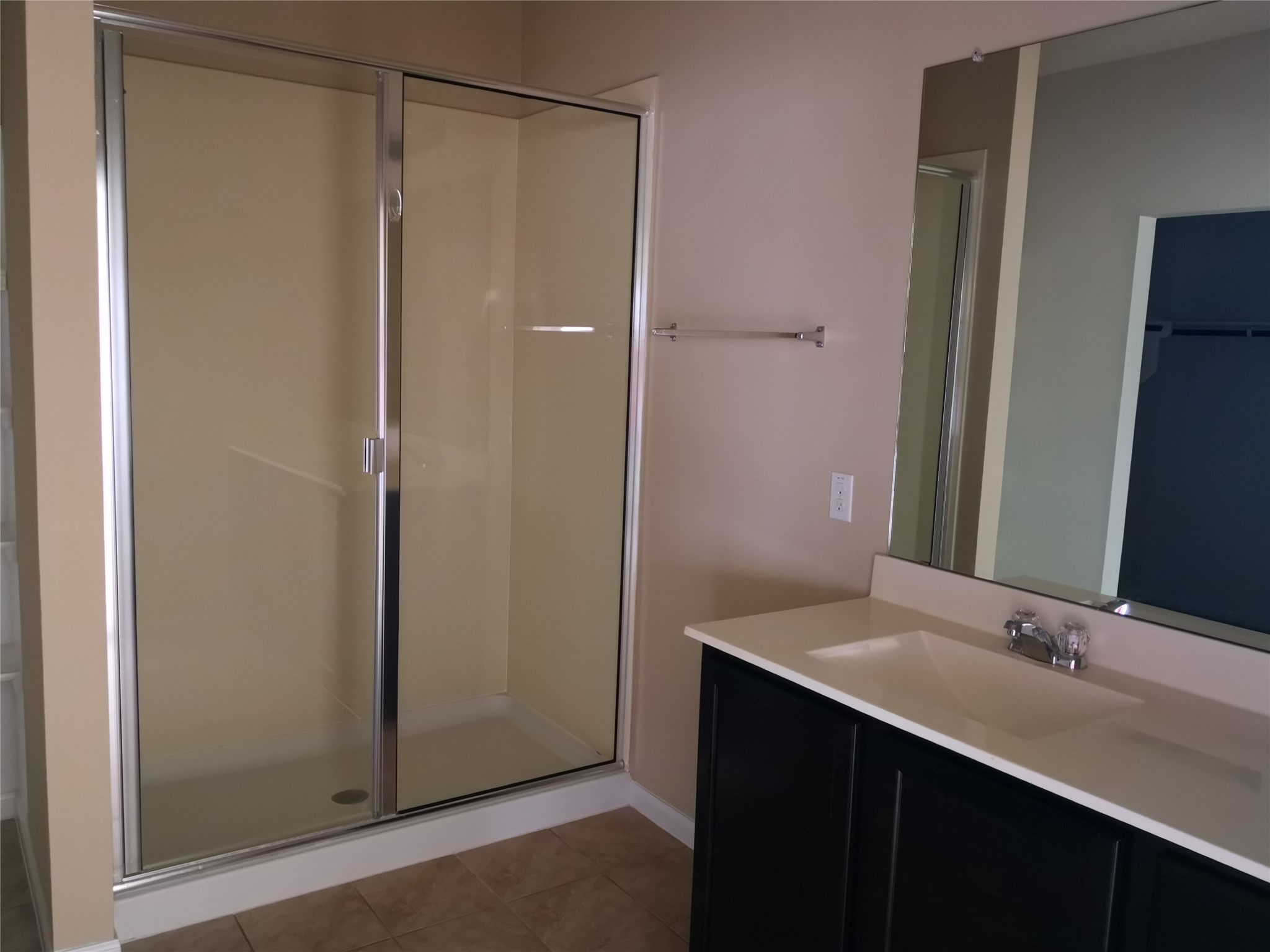 1602 Atlas Road Cedar Park, TX 78613 - Photo 6 of 13 Bathroom with a stall shower, vanity, light tile patterned flooring, and a walk in closet