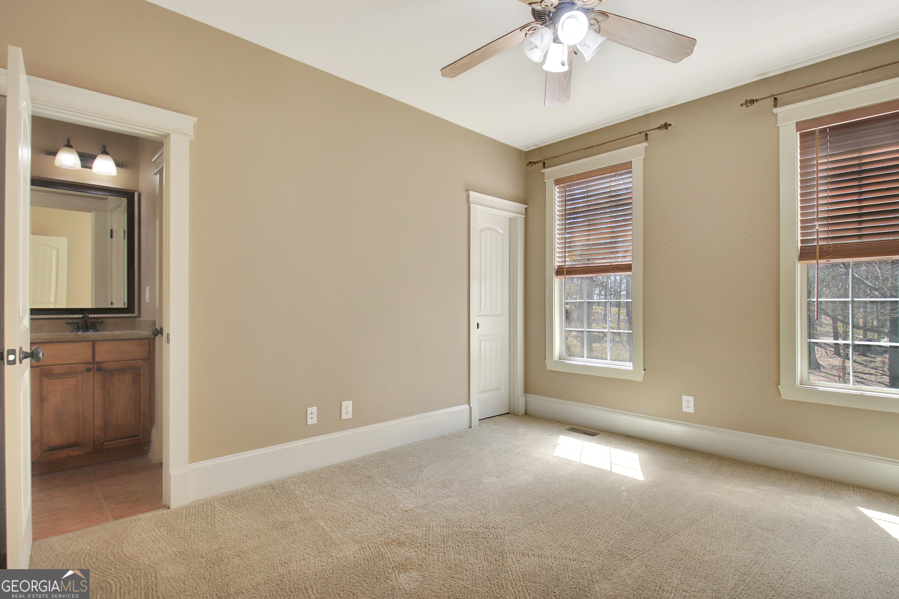373 Blanton Mill Road Williamson, GA 30292 - Photo 31 of 57 an empty room with chandelier fan and windows