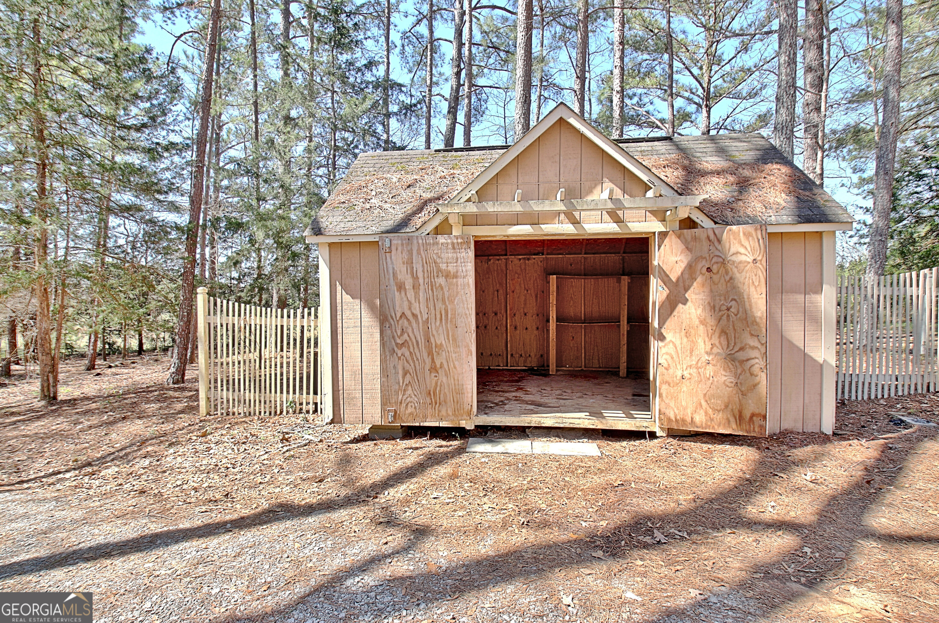 373 Blanton Mill Road Williamson, GA 30292 - Photo 46 of 57 a view of house with wooden fence next to a road