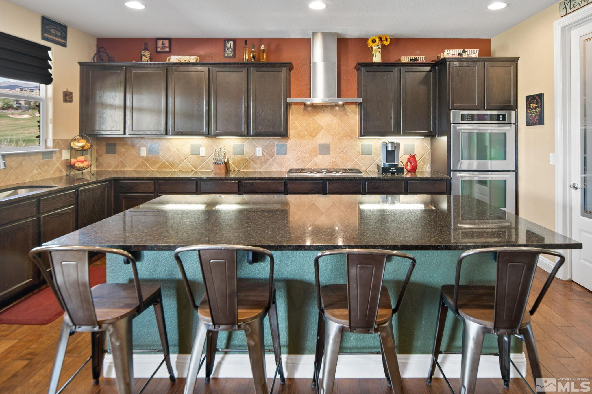 2055 Back Nine Trail Reno, NV 89523 - Photo 13 of 40 a kitchen with a table chairs refrigerator and microwave