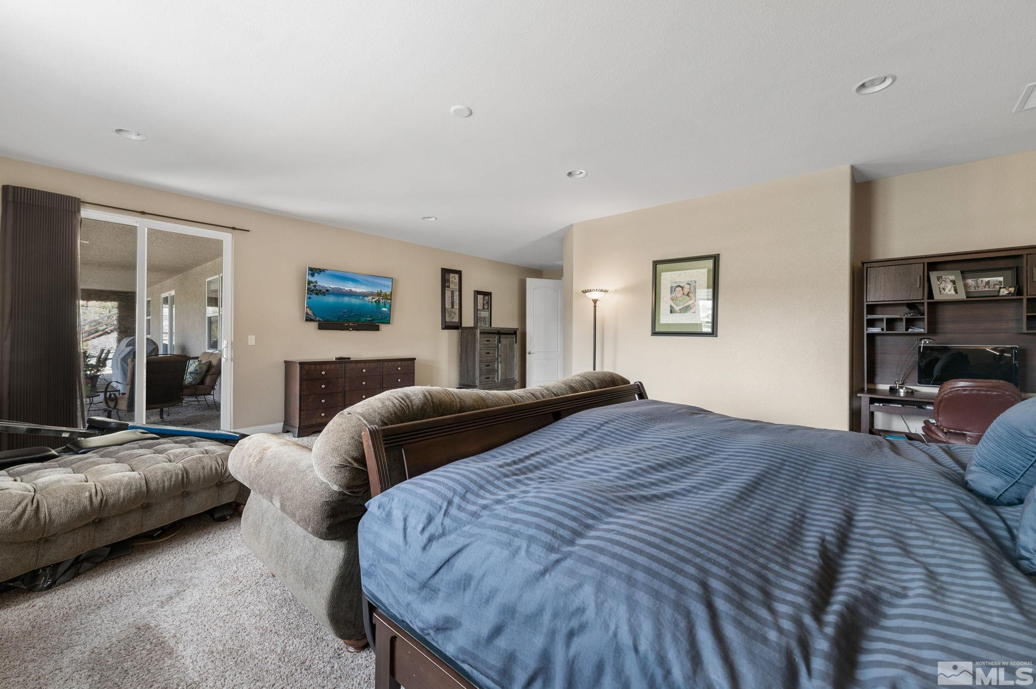 2055 Back Nine Trail Reno, NV 89523 - Photo 19 of 40 a bedroom with a large bed and a couch