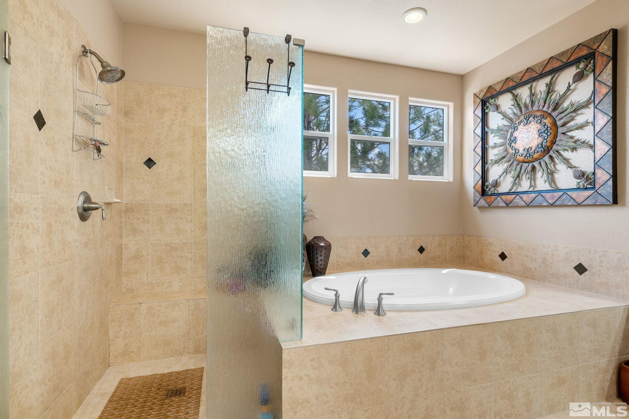 2055 Back Nine Trail Reno, NV 89523 - Photo 23 of 40 a bathroom with a tub a window and a shower