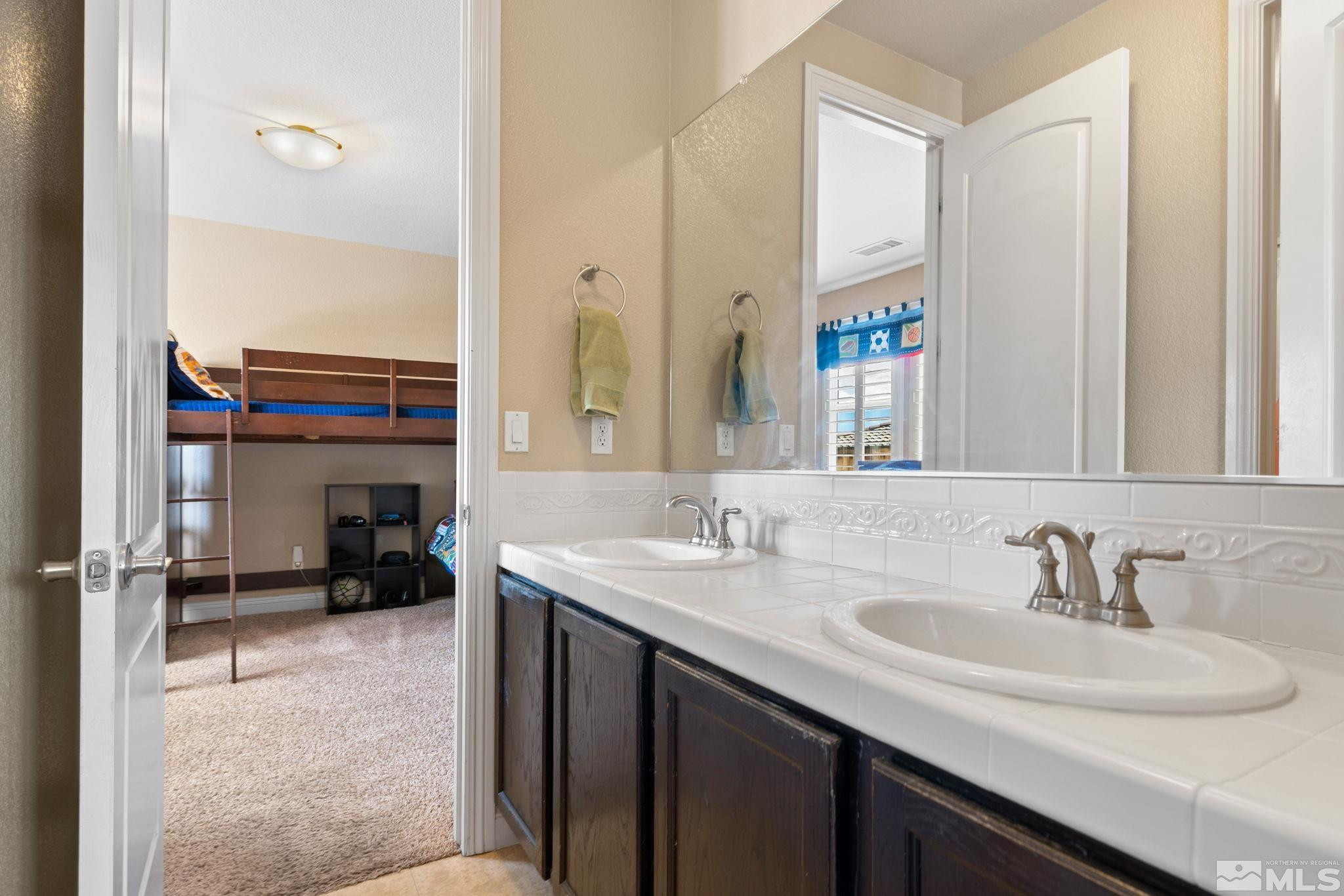 2055 Back Nine Trail Reno, NV 89523 - Photo 28 of 40 a bathroom with a sink double vanity and a mirror