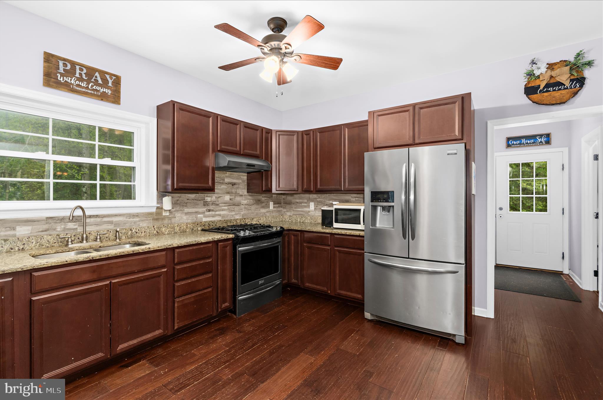 6941 Hubbard Road Hurlock, MD 21643 - Photo 12 of 71 a kitchen with stainless steel appliances granite countertop a refrigerator a stove a sink and a microwave