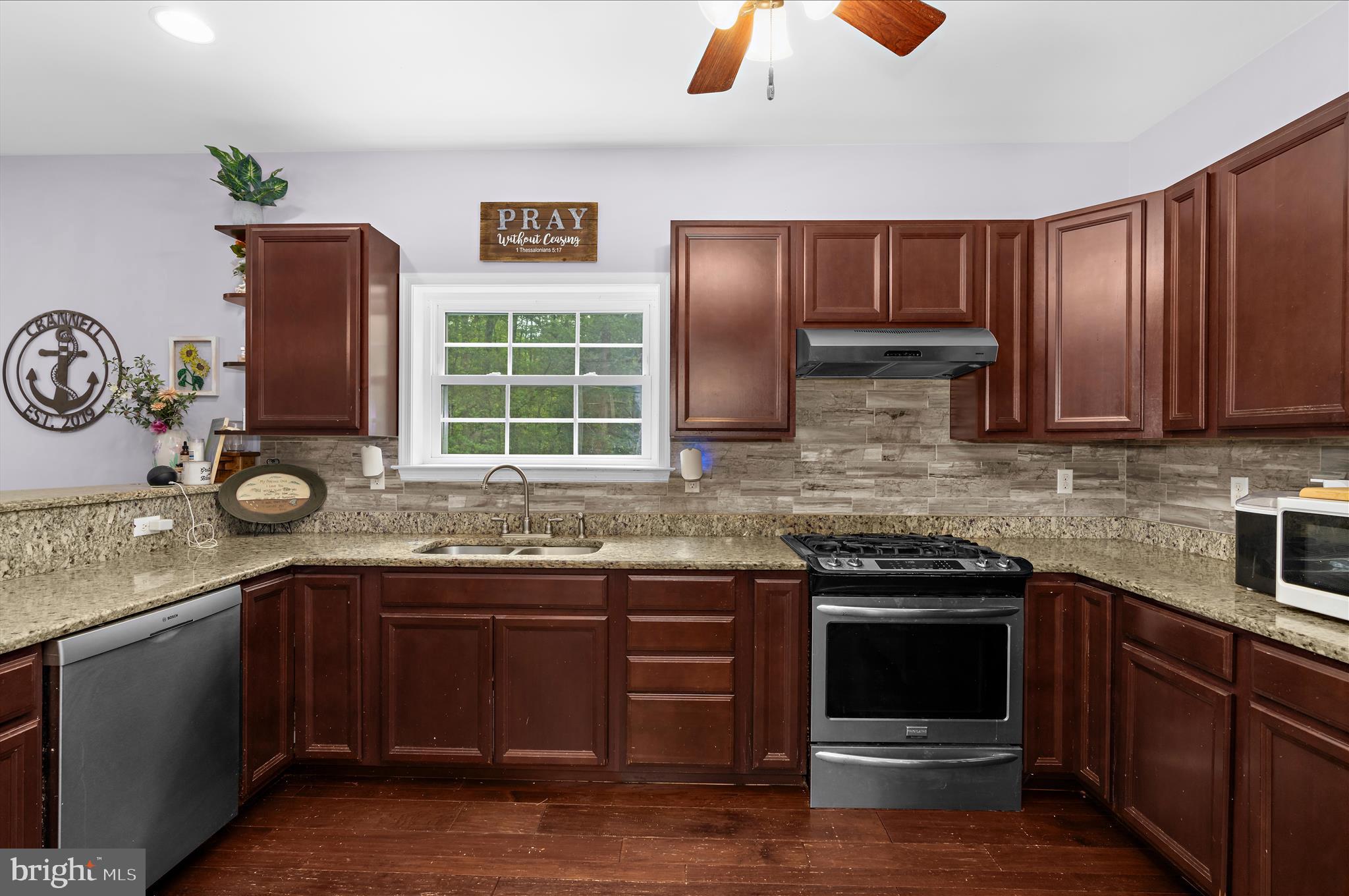6941 Hubbard Road Hurlock, MD 21643 - Photo 14 of 71 a kitchen with stainless steel appliances granite countertop a sink and a stove