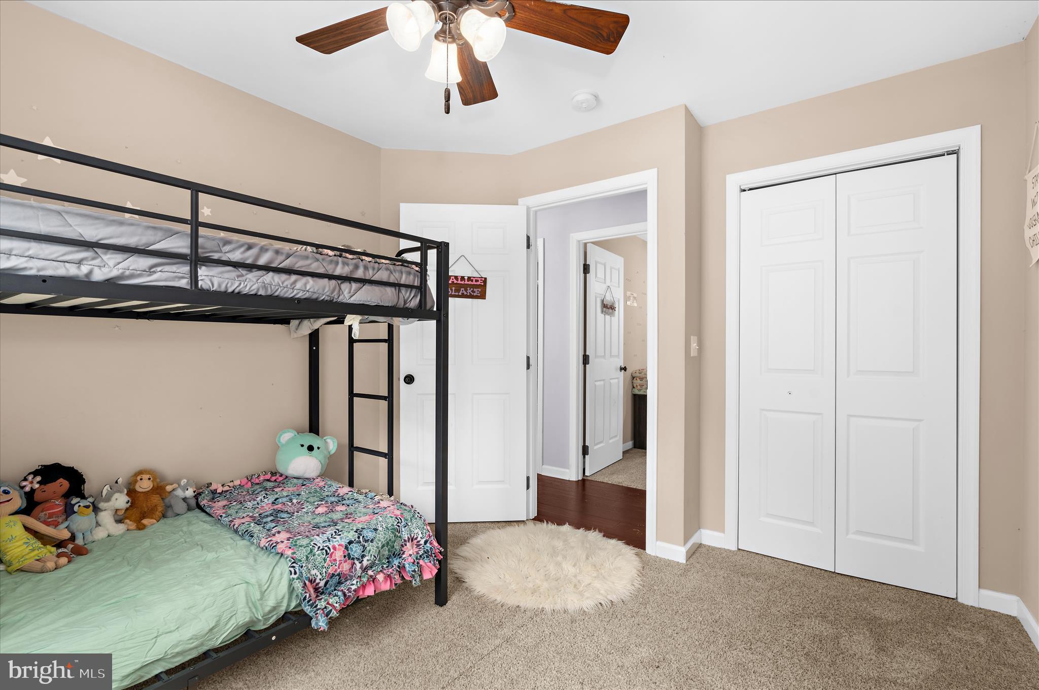 6941 Hubbard Road Hurlock, MD 21643 - Photo 23 of 71 a bedroom with a bed and a chandelier