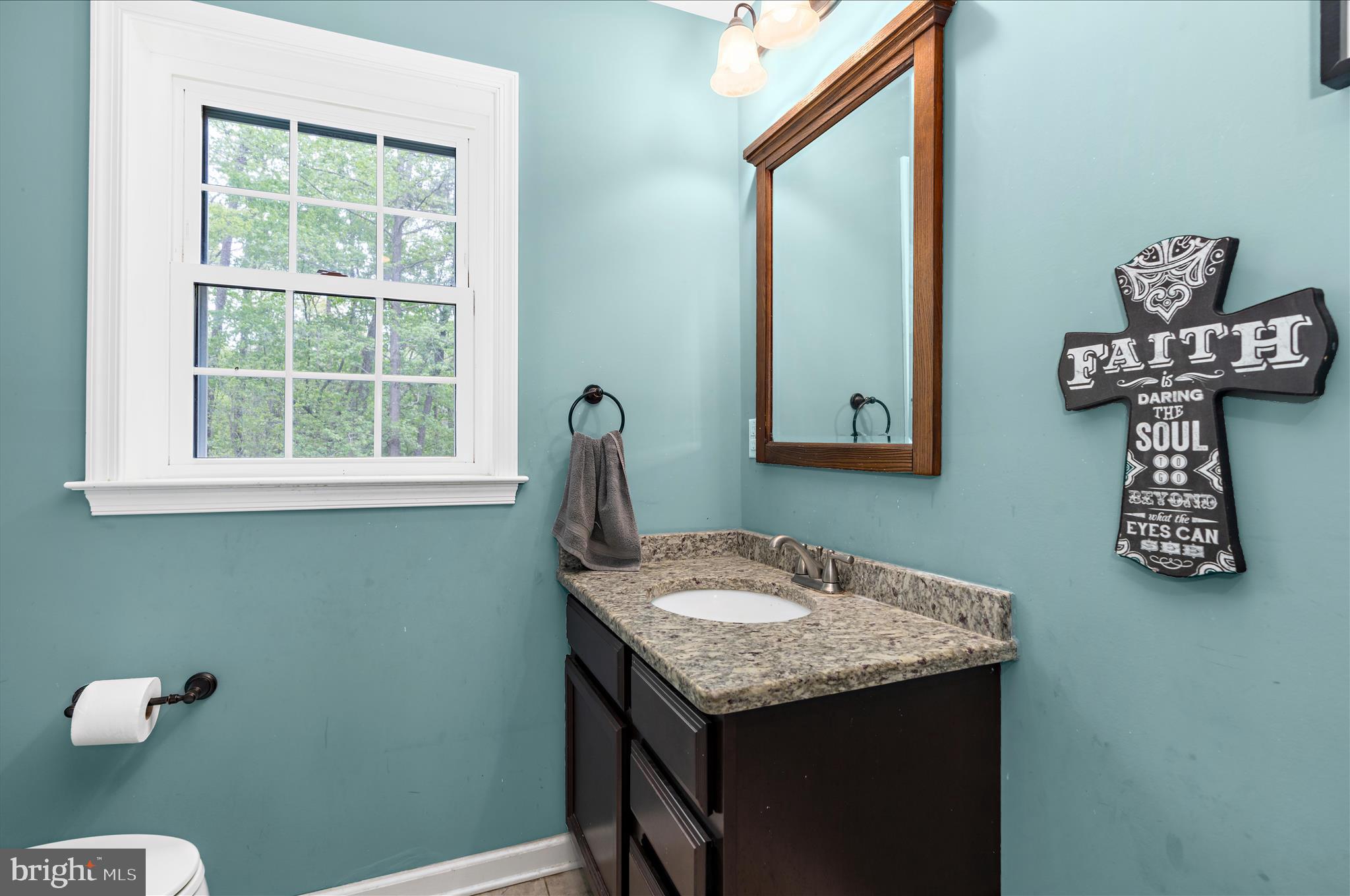 6941 Hubbard Road Hurlock, MD 21643 - Photo 24 of 71 a bathroom with a granite countertop sink and a mirror