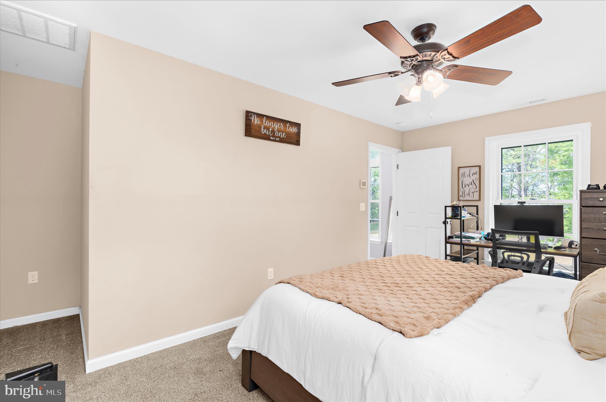 6941 Hubbard Road Hurlock, MD 21643 - Photo 31 of 71 a bedroom with a bed a table and a chandelier