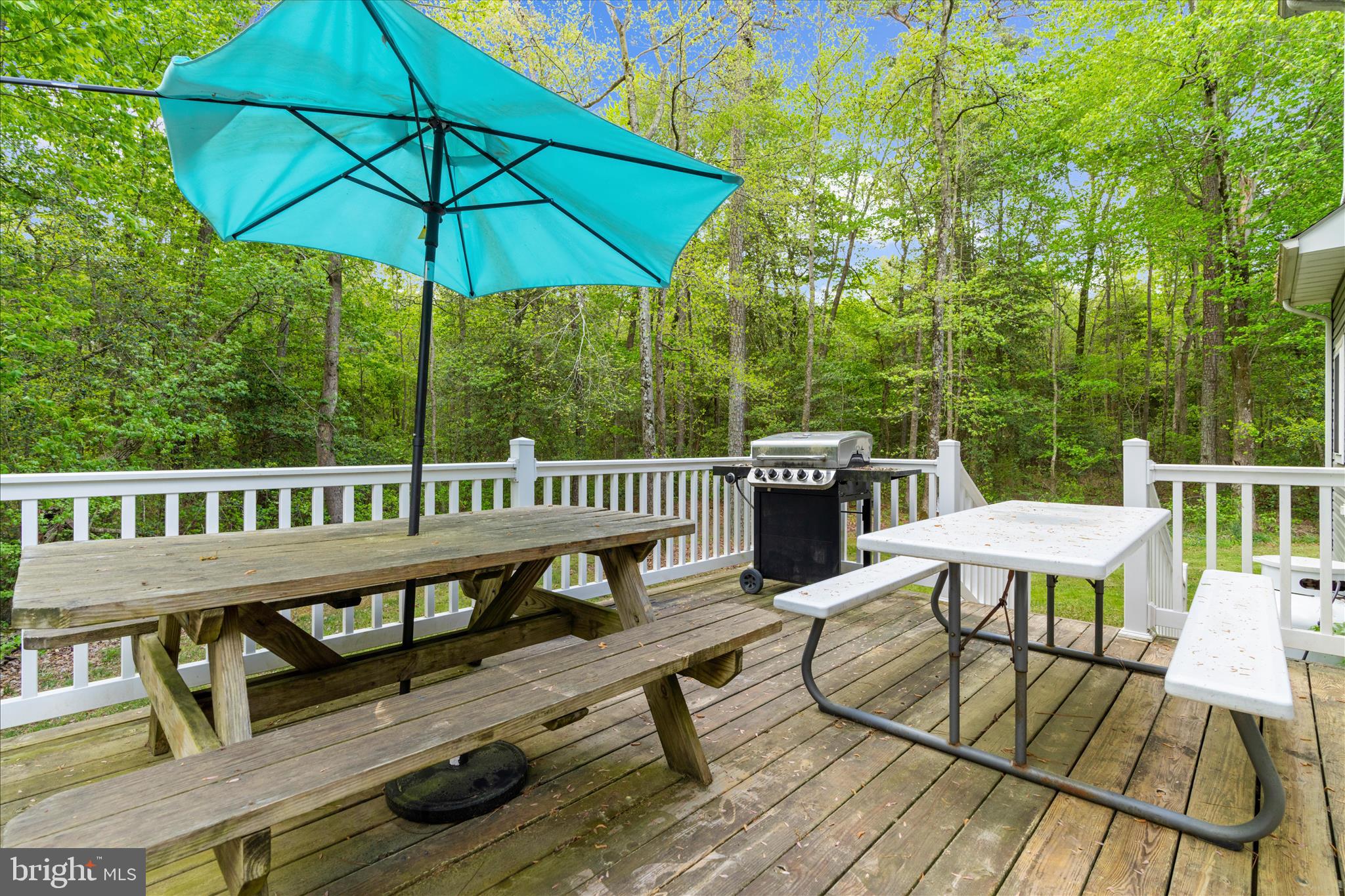 6941 Hubbard Road Hurlock, MD 21643 - Photo 34 of 71 a view of a deck with furniture and umbrella