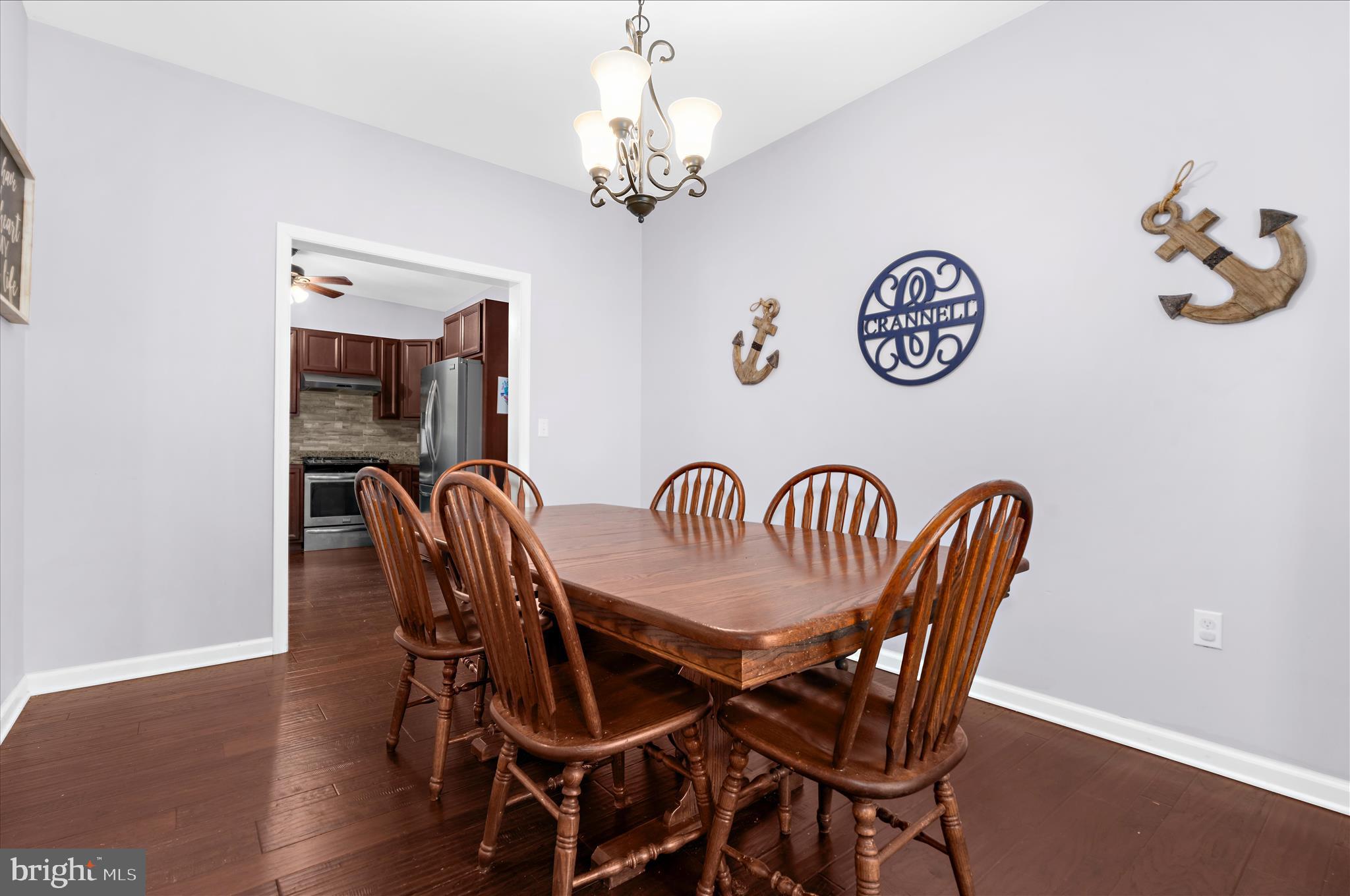 6941 Hubbard Road Hurlock, MD 21643 - Photo 6 of 71 a dining room with furniture a chandelier and wooden floor