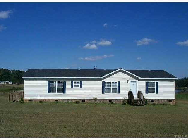 56 Quartergate Road Roxboro, NC 27574 - Photo 1 of 1 a front view of a house with a garden