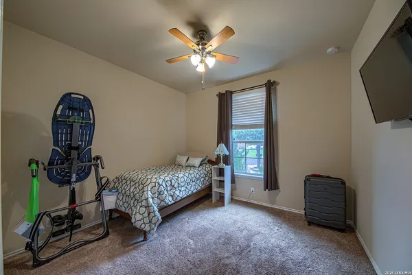 a living room with furniture a flat screen tv and gym equipment