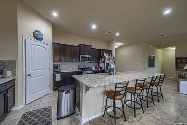 a kitchen with a table and chairs in it