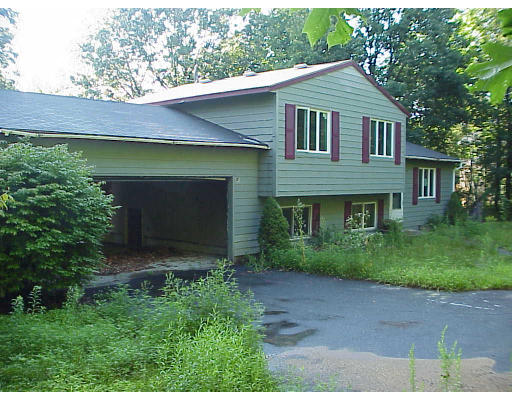 419 Town Farm Road Warren, MA 01092 - Photo 1 of 3 a front view of a house with a garden and plants