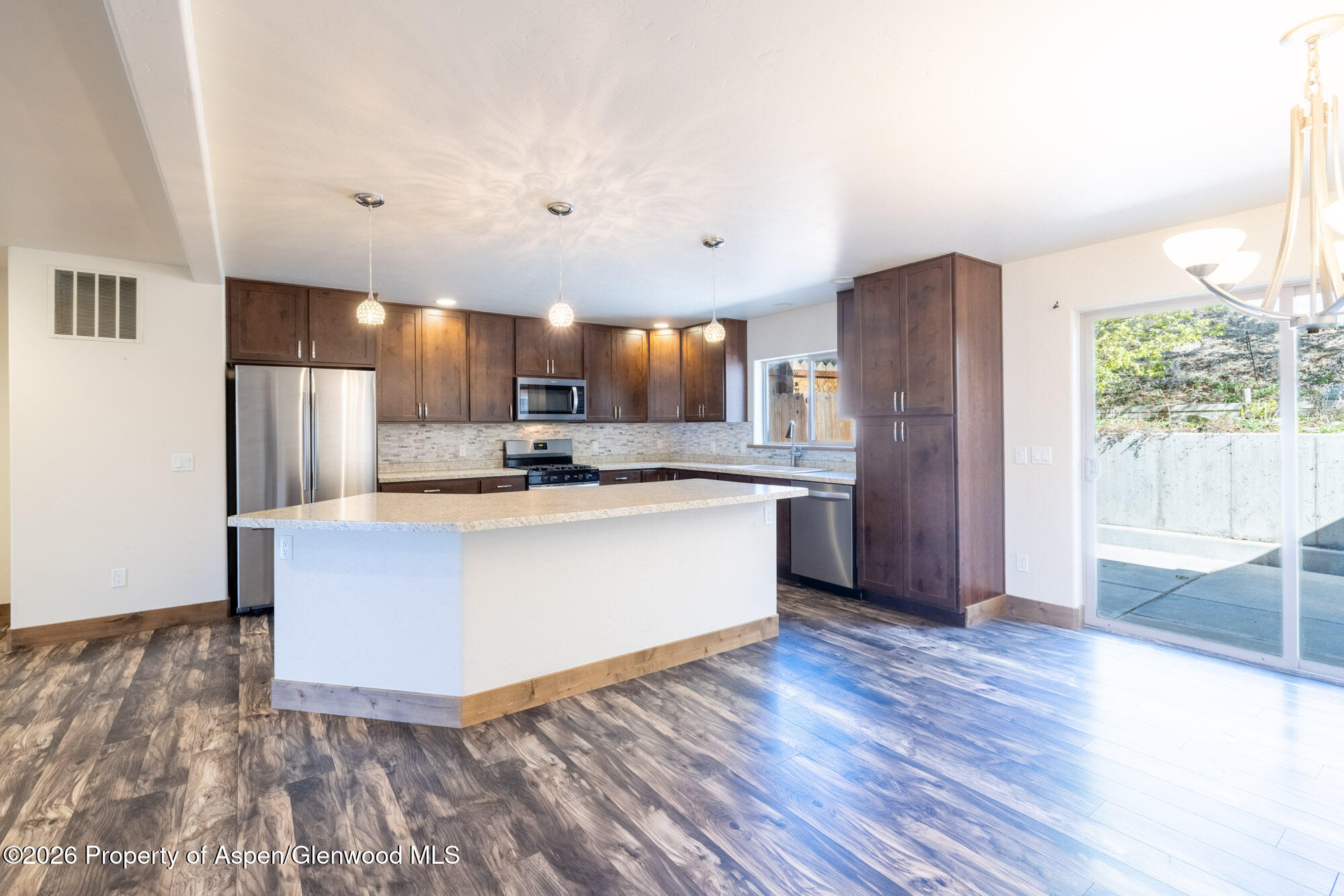2016 Ballard Avenue Silt, CO 81652 - Photo 5 of 23 a view of kitchen with stainless steel appliances granite countertop a stove a refrigerator a sink and a oven with wooden floor