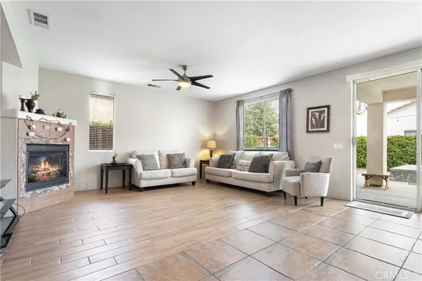 a living room with furniture and a fireplace