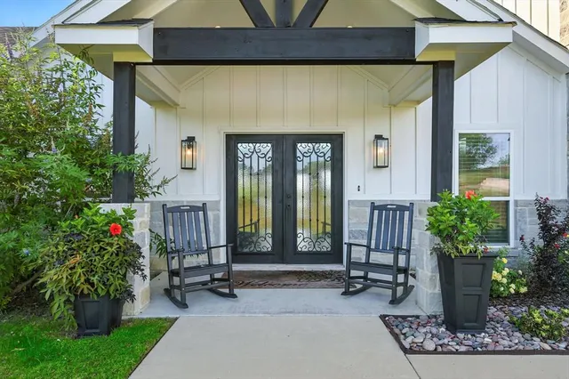 a building outdoor space with patio furniture and potted plants