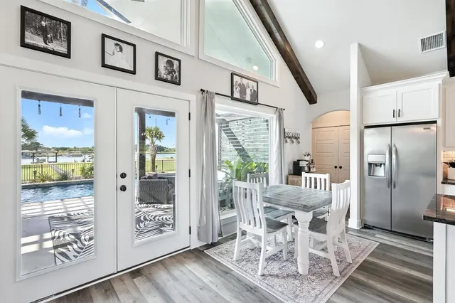 a dining room with furniture a rug and wooden floor