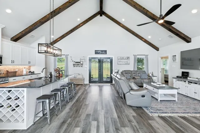 a living room with furniture and a wooden floor