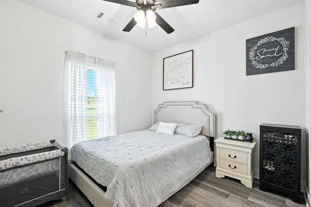 a bedroom with a large bed and a window