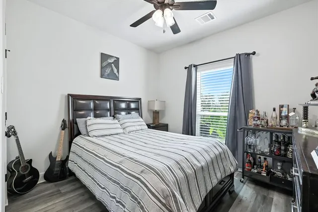 a bedroom with a bed a large window and book self