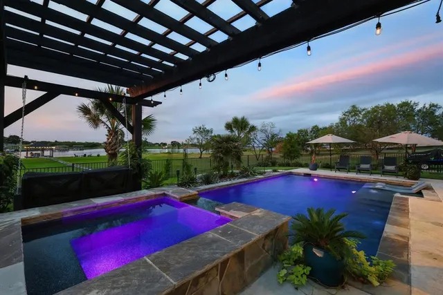 a view of a pool patio and outdoor seating