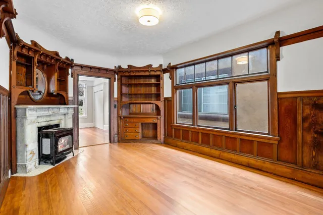 a dining room with furniture and wooden floor