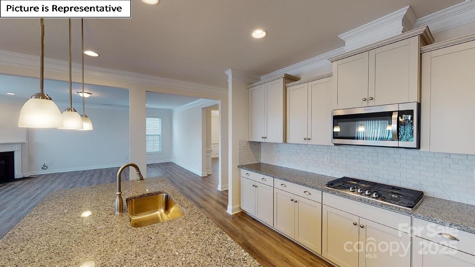 6136 Sylvan Drive Denver, NC 28037 - Photo 15 of 45 a kitchen with stainless steel appliances granite countertop a sink a stove and a wooden cabinets