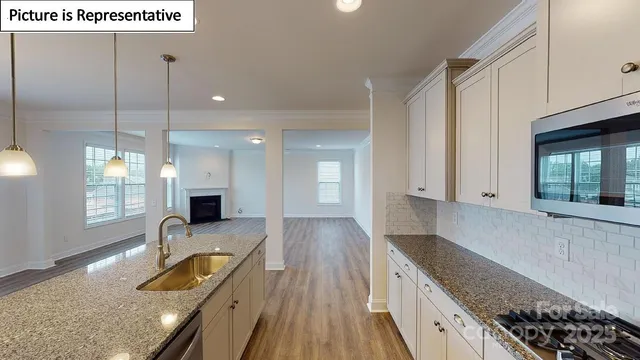 a kitchen with sink refrigerator and window