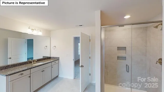 a spacious bathroom with a shower sink and mirror
