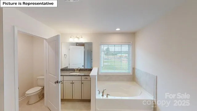 a bathroom with a granite countertop toilet a sink and bathtub