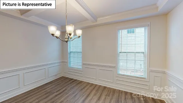 a view of a livingroom with wooden floor and a large window