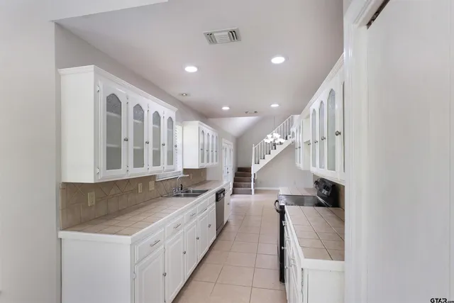 a kitchen with a sink and cabinets
