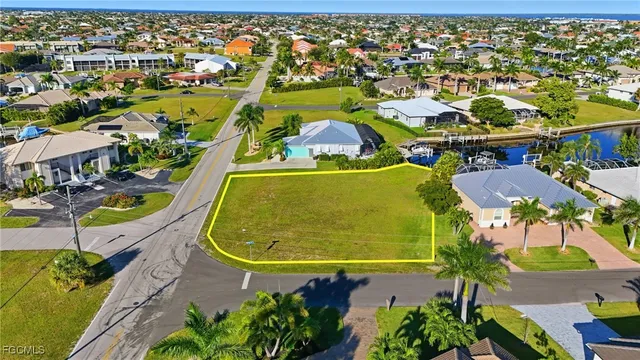 an aerial view of residential houses with outdoor space and swimming pool