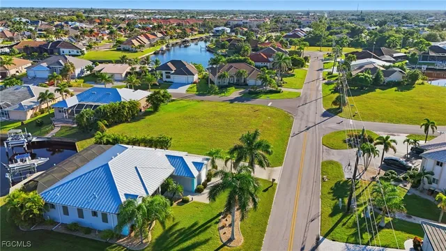 an aerial view of residential houses with outdoor space and swimming pool