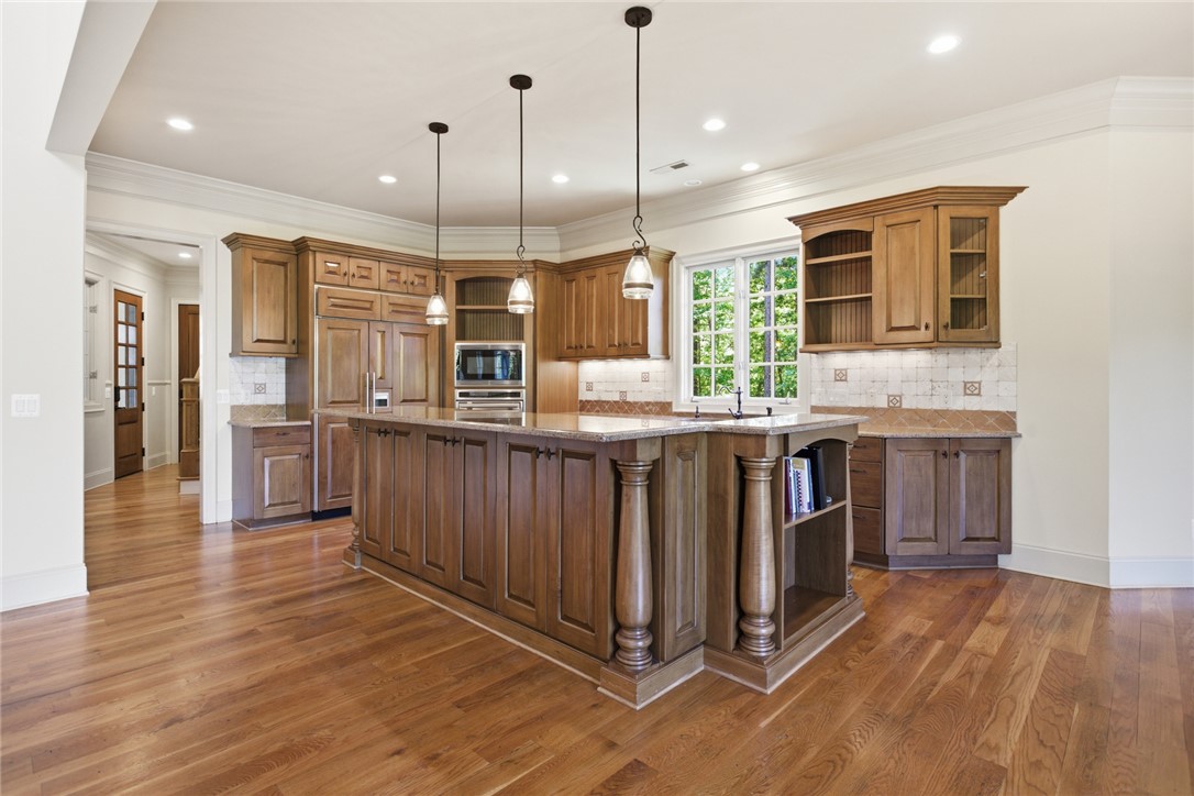 130 River Ridge Road Sunset, SC 29685 - Photo 4 of 47 A well-appointed culinary space featuring rich wood cabinetry, a generous central island, and abundant natural light.
