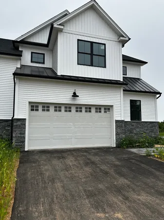 a front view of a house with garage