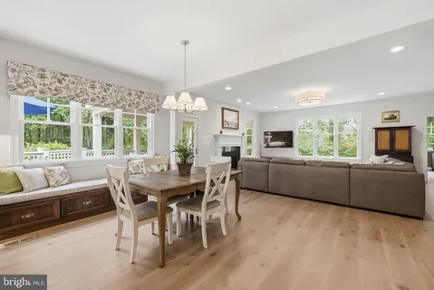 a living room with furniture a large window and a fireplace
