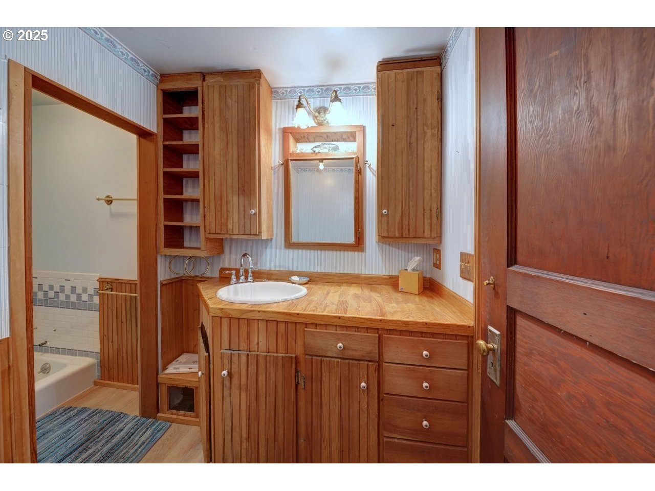 123 West 1st Street Cannon Beach, OR 97110 - Photo 19 of 35 a bathroom with a granite countertop sink and a mirror