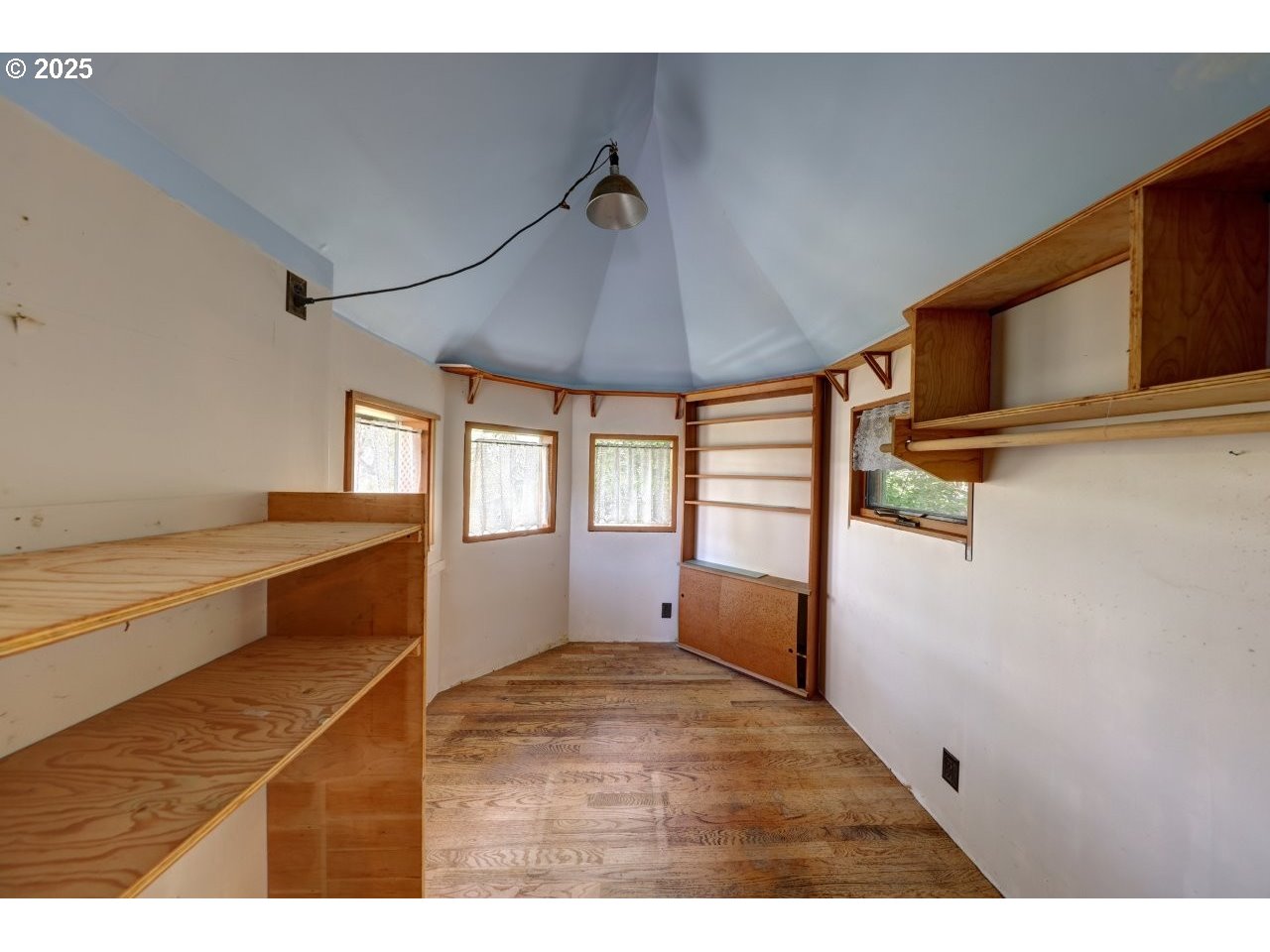 123 West 1st Street Cannon Beach, OR 97110 - Photo 28 of 35 a view of an empty room with wooden floor and a window