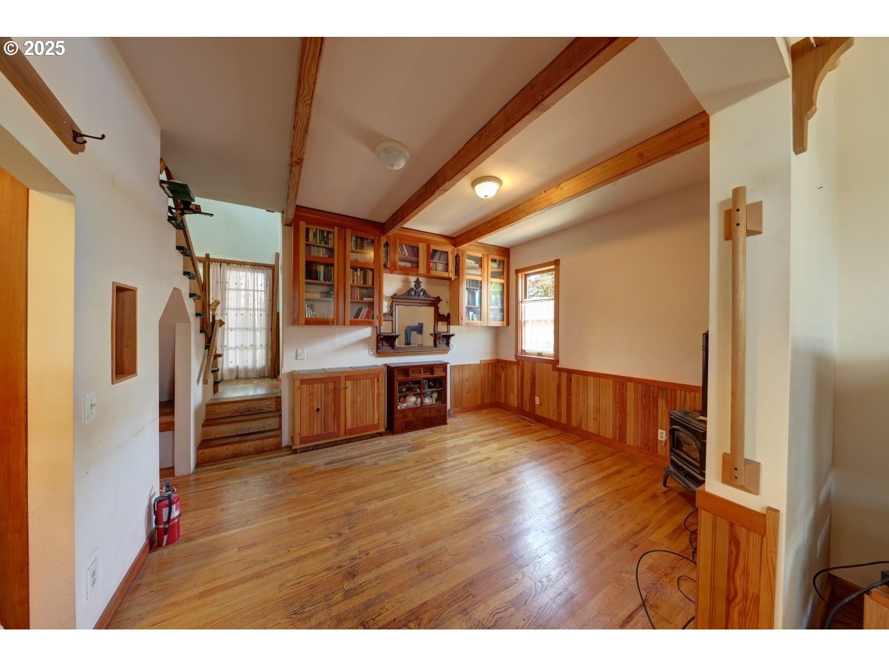 123 West 1st Street Cannon Beach, OR 97110 - Photo 10 of 35 a kitchen with stainless steel appliances kitchen island wooden floors and refrigerator