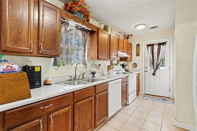 a kitchen with a sink window and cabinets