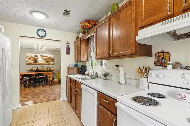 a kitchen with a sink a stove and cabinets