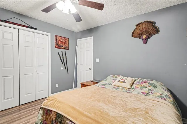 a bedroom with a bed and a chandelier