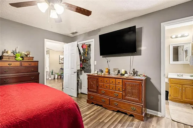 a bedroom with a bed and flat screen tv