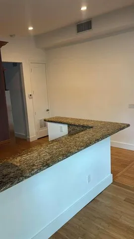 a view of a kitchen with wooden floor