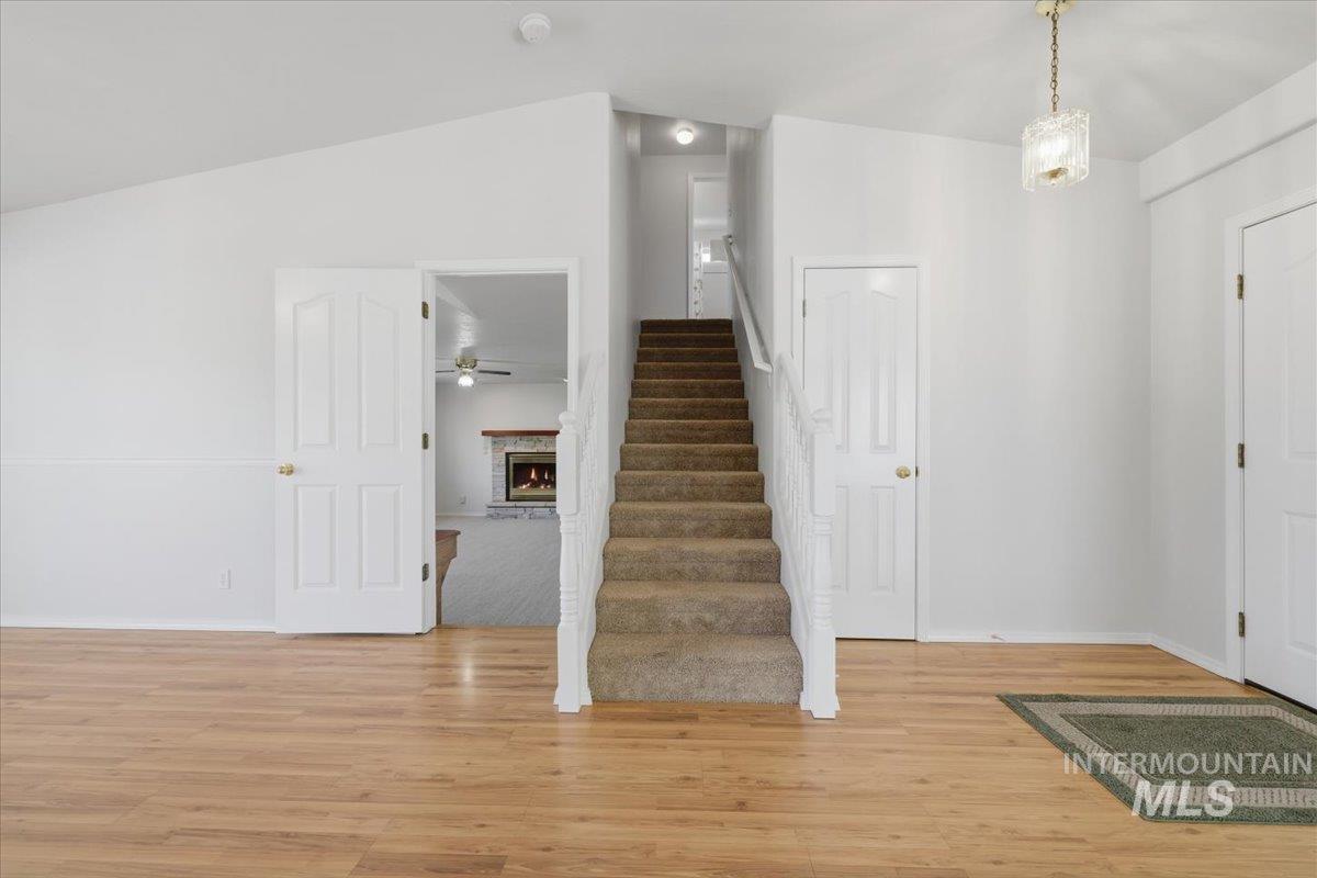 1128 West State Street Meridian, ID 83642 - Photo 10 of 50 Central staircase with white balusters and carpeted treads
