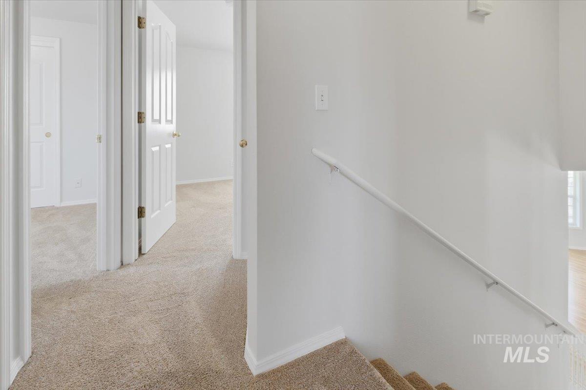 1128 West State Street Meridian, ID 83642 - Photo 32 of 50 Upper-level landing featuring neutral carpeting, white trim, and white paneled doors