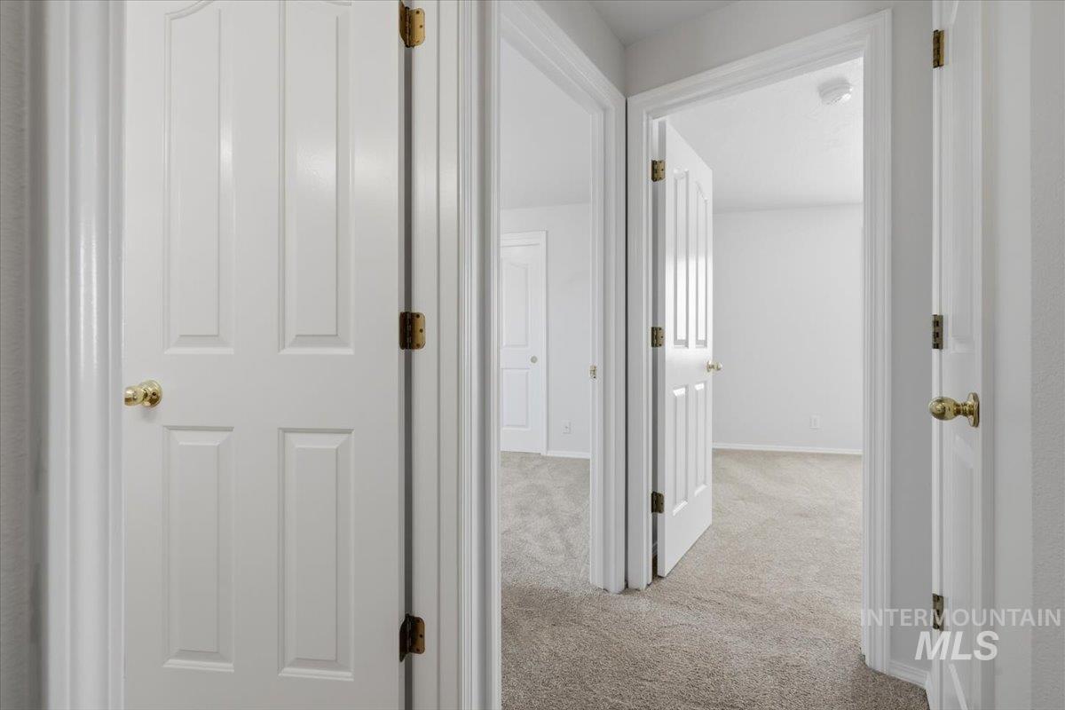 1128 West State Street Meridian, ID 83642 - Photo 33 of 50 Interior hallway featuring light beige carpeting and white painted walls