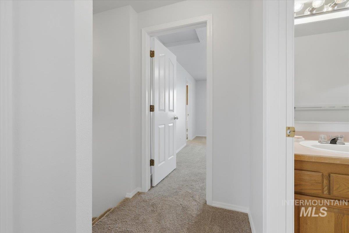 1128 West State Street Meridian, ID 83642 - Photo 34 of 50 Carpeted hallway with white walls and trim